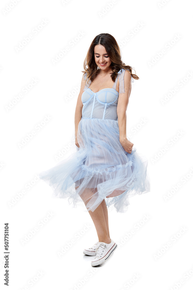 Naklejka premium Happy young woman in blue dress on white