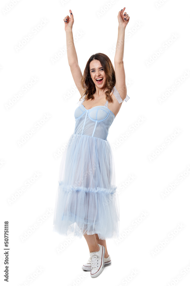 Happy young woman in blue dress on white