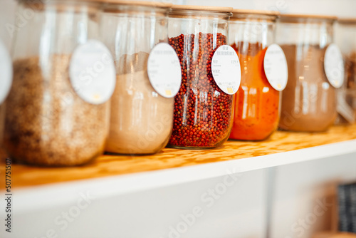 Ingredient jars with labels on shelf at cafe