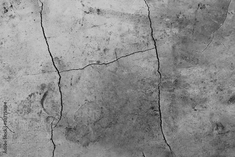 Obraz premium Close-up of an abstract gray concrete texture background with cracks and bumps.