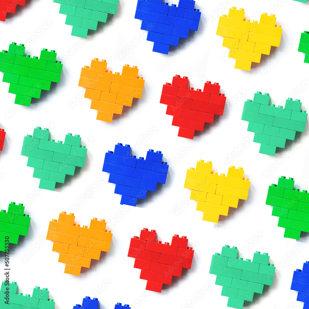 Colors Hearts from blocks as background, minimal geometric pattern from plastic blocks, shapes heart from child construction. Top view repeat colorful pattern, Toys, games