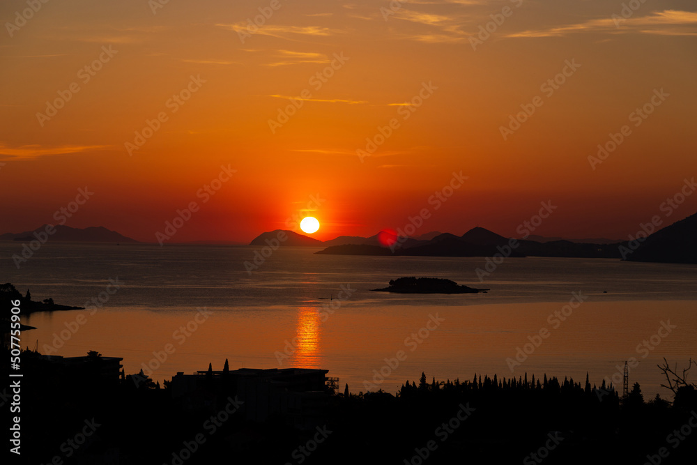 Sunset over mountains and sea. Adriatic coast of Croatia.
