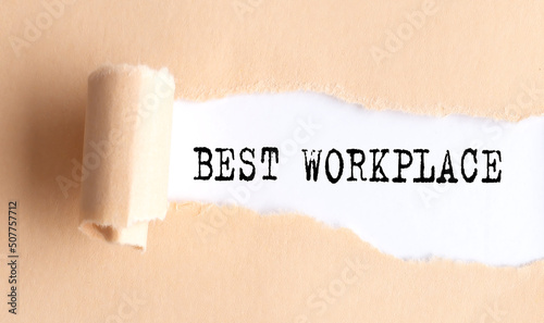 The text THE BEST WORKPLACE appears on torn paper on white background.