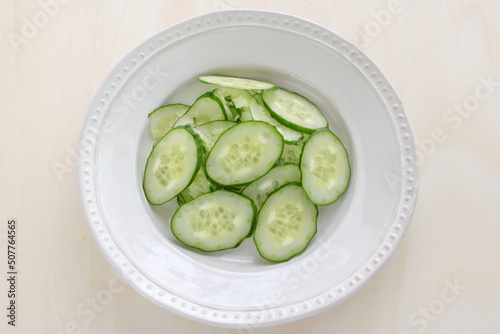 Sliced cucumber on dish with copy space for cooking ingredient 
