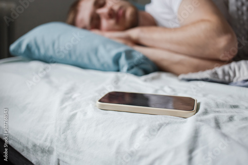 The phone next to the sleeping man