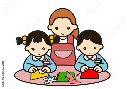 おりがみを折る子供たちと先生