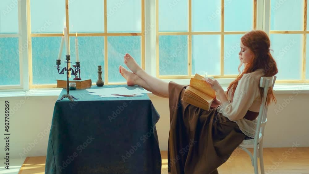 red-haired medieval woman sits on chair, legs lie on table, brutal pose ...