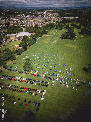 The North Inch in Perth, Scotland, by drone showing the volleyball tournament from the sky. Features Bells Sports Centre and the cars parked on the grass