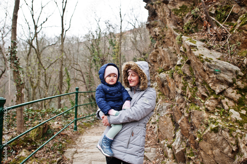 Mother with daughter, wear in jacket walking at Znojmo park in Czech Republic