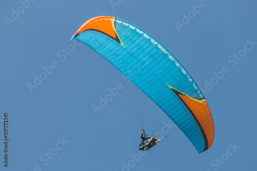 Fototapeta Naklejka Na Ścianę i Meble -  Twin paraglider. Paragliding against the blue sky.