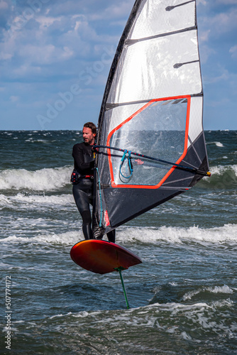 Wind Foil Surfer surf in the sea, close up