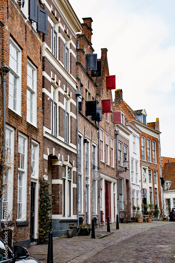 historical buildings  with colorful window shutters in a small street in the Netherlands