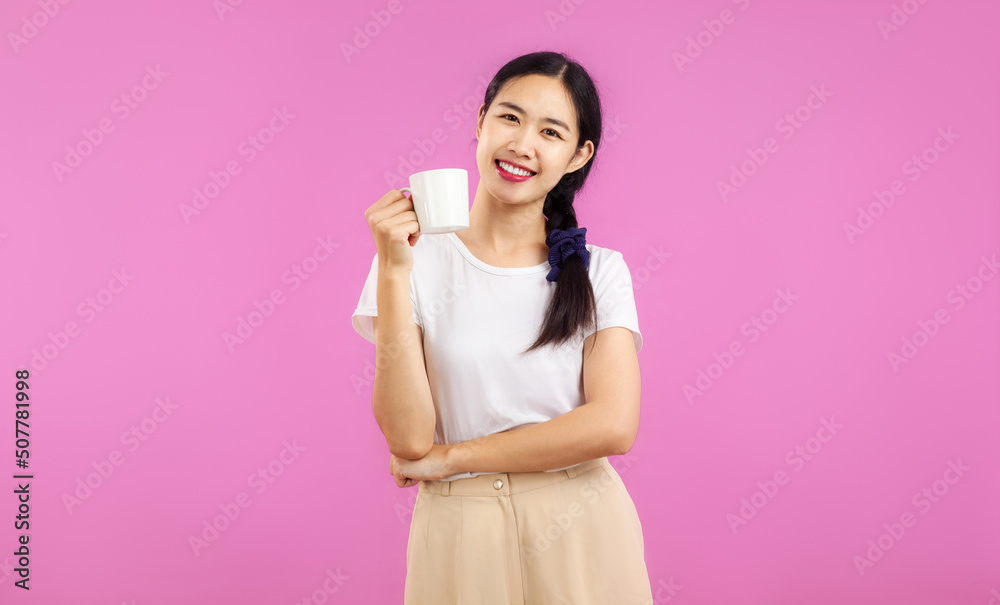 portrait of a pretty asian woman with a cup isolated on pink background portrait of a pretty asian woman with a cup isolated on pink background