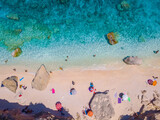 Golfo di Orosei Sardina, View from above, stunning aerial view of a beach full of beach umbrellas and people sunbathing and swimming on turquoise water. Cala Gonone, Sardinia, Italy, Cala Mariolu.