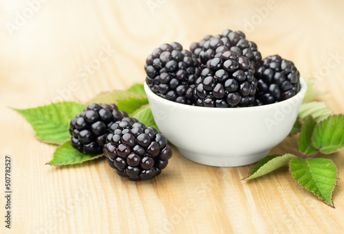 plate with blackberries on a wooden table