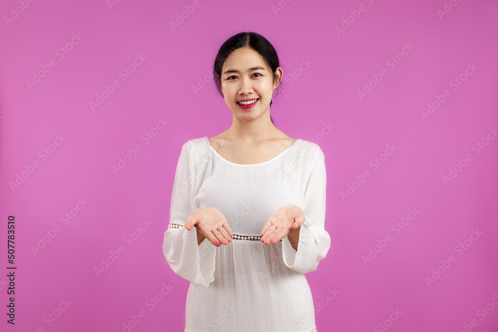 Young pretty asian woman in white dress posing on the pink screen background. Young pretty asian woman in white dress posing on the pink screen background.