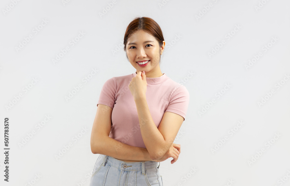 Photo of Young asian woman in pink pastel top posing excited and surprised emotional face on the white background. Photo of Young asian woman in pink pastel top posing excited and surprised emotional face on the white background.