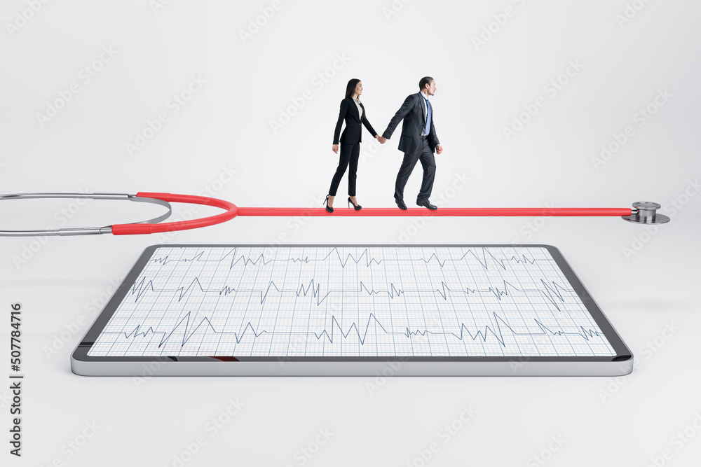 Young european businessman and woman walking on stethoscope above tablet with cardiology screen on light background. Medicine and doctor, healthcare concept. Young european businessman and woman walking on stethoscope above tablet with cardiology screen on light background. Medicine and doctor, healthcare concept.