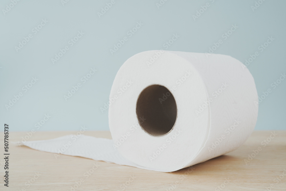roll of hygiene white tissue paper on wooden desk in soft focus roll of hygiene white tissue paper on wooden desk in soft focus