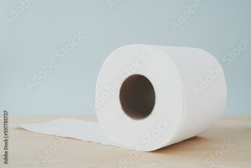 roll of hygiene white tissue paper on wooden desk in soft focus
