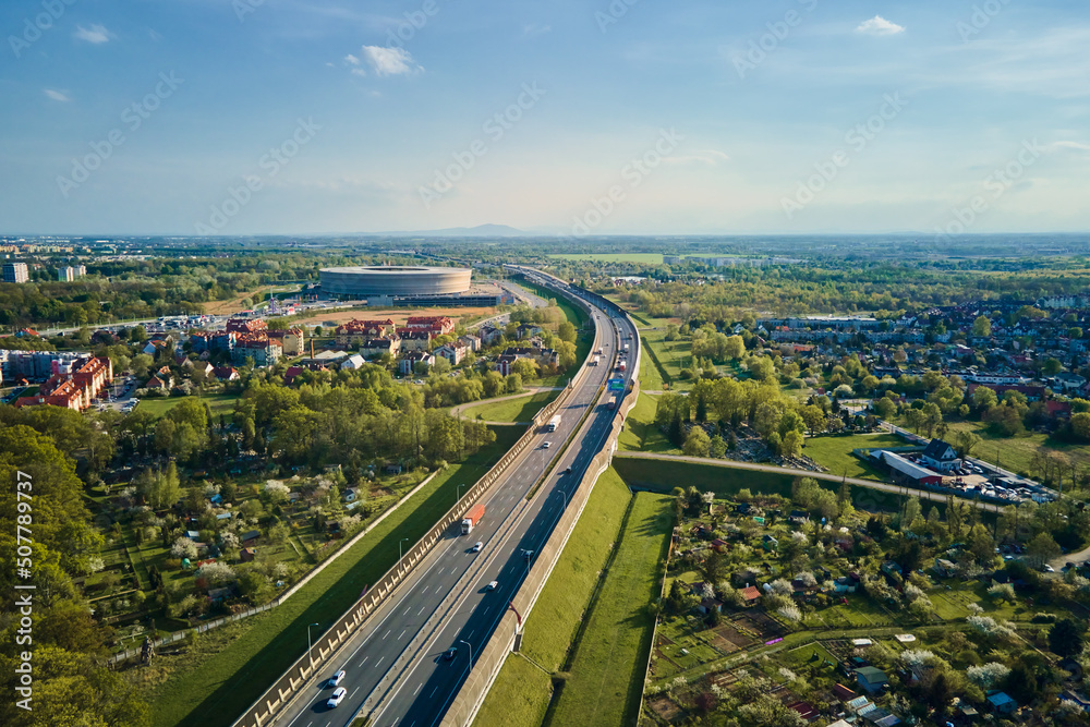 Aerial view of Wroclaw cityscape with residential districts, stadium and car traffic road