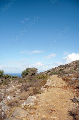 Paved stone path among the hills, Crete island, Greece.