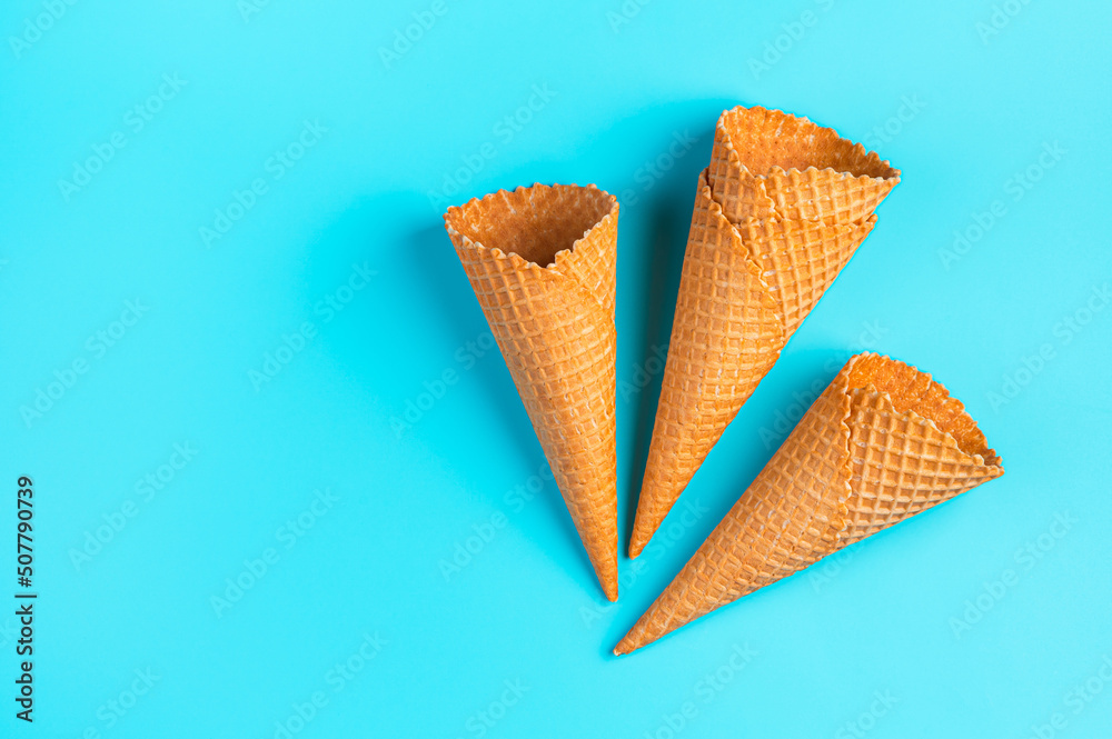 Waffle ice cream cups on a blue background. Top view Waffle ice cream cups on a blue background. Top view