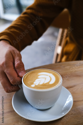 A cup of hot latte coffee on the table for breakfast 