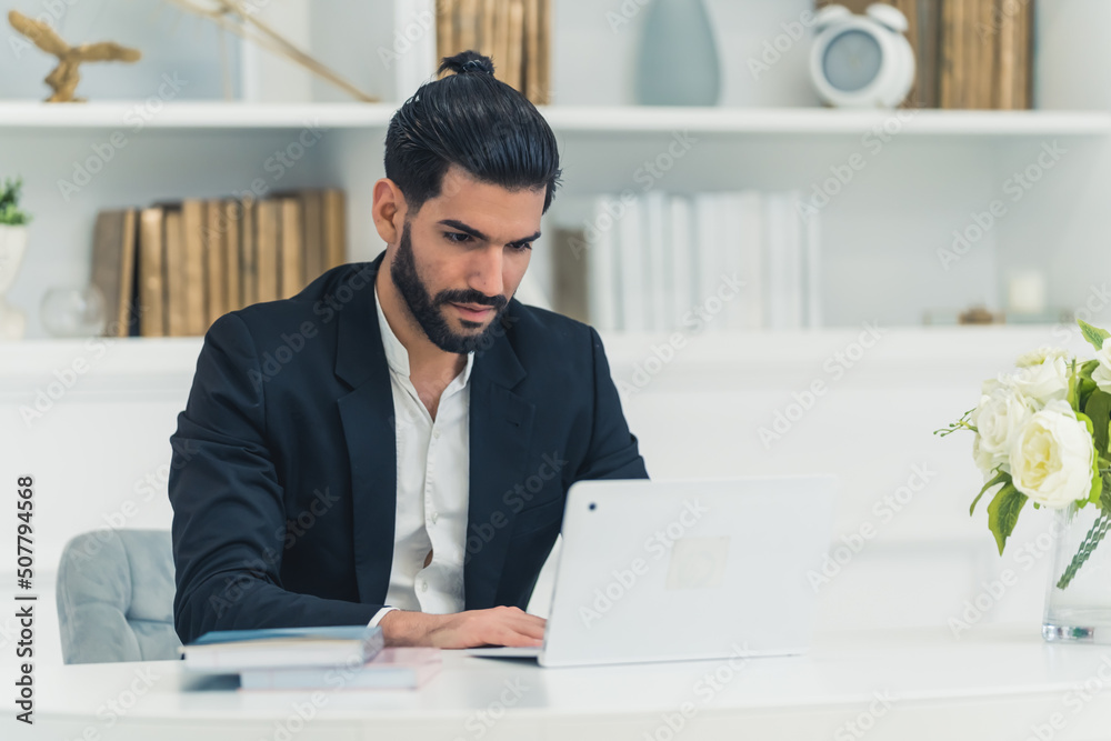 Focused adult Latin bearded man looking at his laptop, home office concept. High quality photo Focused adult Latin bearded man looking at his laptop, home office concept. High quality photo
