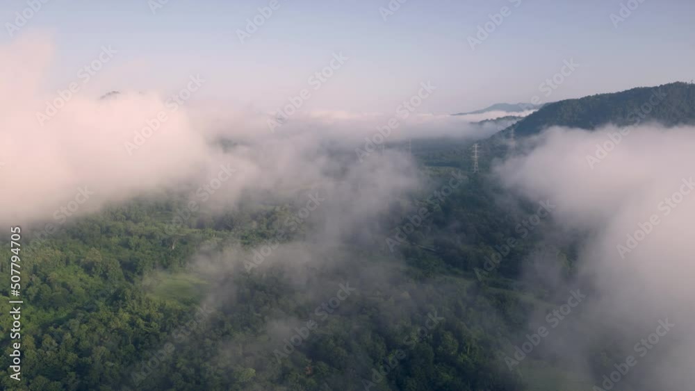 Video 4K, Aerial view Morning scenic on high mountains with electricity pylon Pang Puay, Mae Moh, Lampang, Thailand. Beautiful morning with golden sunrise and fog flowing. Video 4K, Aerial view Morning scenic on high mountains with electricity pylon Pang Puay, Mae Moh, Lampang, Thailand. Beautiful morning with golden sunrise and fog flowing.