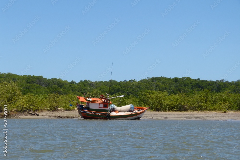 Fishing boat parked and isolated on a deserted beach in Alcântara, Maranhã, Brazil.