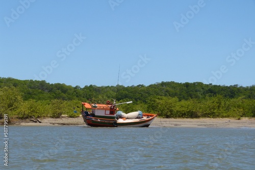 Fishing boat parked and isolated on a deserted beach in Alcântara, Maranhã, Brazil. © Elis Cora