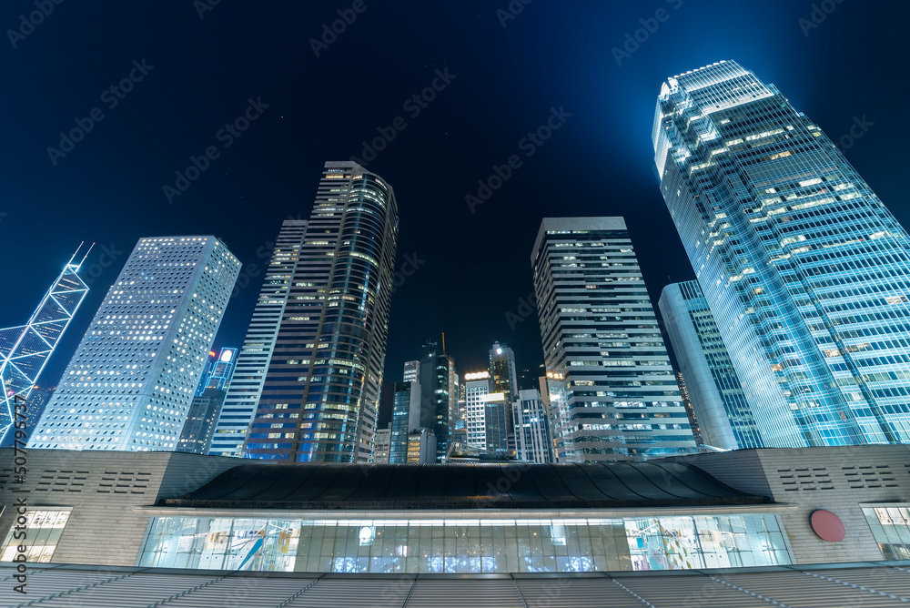 Modern office building and skyline of Hong Kong city at night