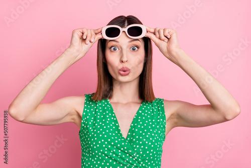 Photo of young woman impressed look see hands touch eyeglasses reaction isolated over pink color background