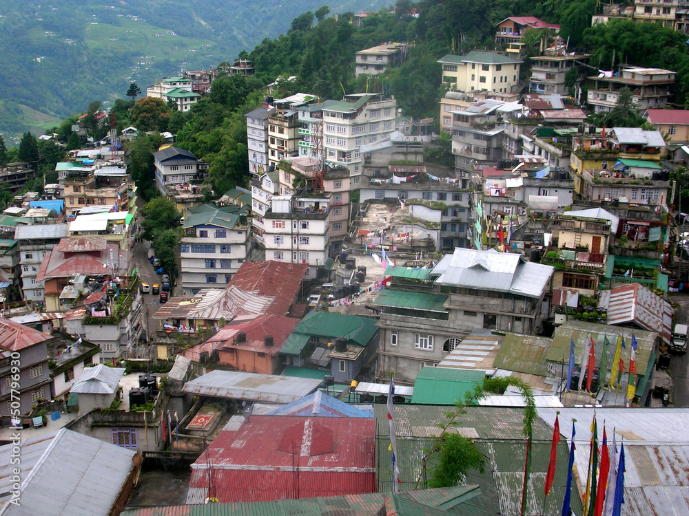 Fototapeta premium A view of Gangtok city with full of buildings established in the hill top. According to the Geological Survey of India, Sikkim falls in 4th seismic zone, where high concrete structures are not allowed