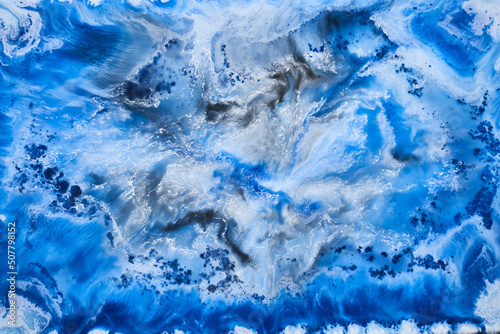 Blue ink abstract background, winter paint pattern under water, acrylic pigment stains, splashes and streaks