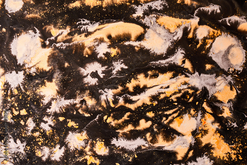 Ink abstract background, paint pattern under water, orange black pigment acrylic stains, splashes and streaks
