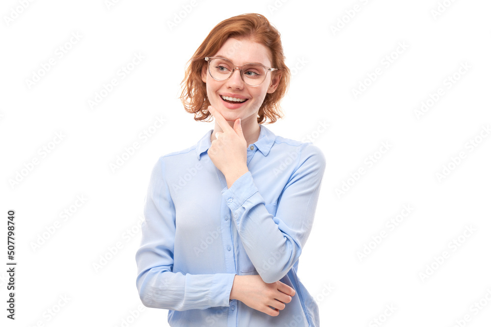 Smart redhead girl in glasses and business shirt holding chin thinks doubts, makes decision isolated on white studio background Smart redhead girl in glasses and business shirt holding chin thinks doubts, makes decision isolated on white studio background