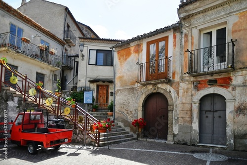 Fototapeta Naklejka Na Ścianę i Meble -  A narrow street between the old houses of Marsicovetere, a village in the mountains of Basilicata, Italy.