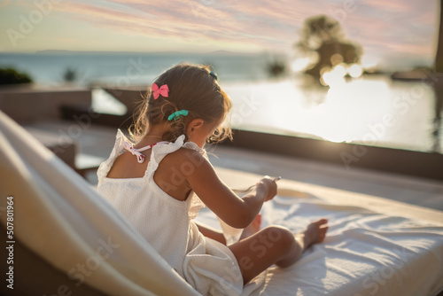 Cute girl eating ice cream near pool