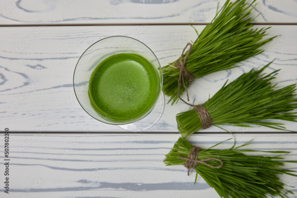 In glass poured the most useful freshly squeezed drink of green color from wheat microgreens. Wheatgrass effects weight loss by reducing hunger and blocking appetite In glass poured the most useful freshly squeezed drink of green color from wheat microgreens. Wheatgrass effects weight loss by reducing hunger and blocking appetite