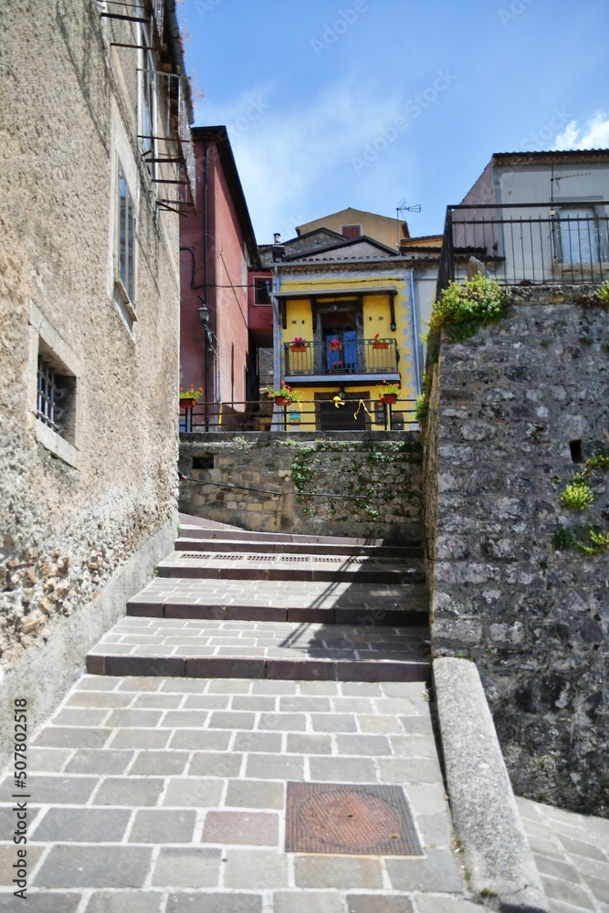 A narrow street between the old houses of Marsicovetere, a village in the mountains of Basilicata, Italy.