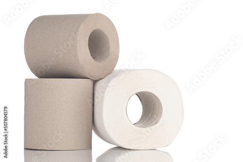 Rolls of toilet paper made from virgin cellulose and recycled materials stacked on a white isolated background