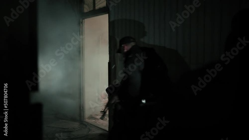 A soldier throws a grenade inside the room.