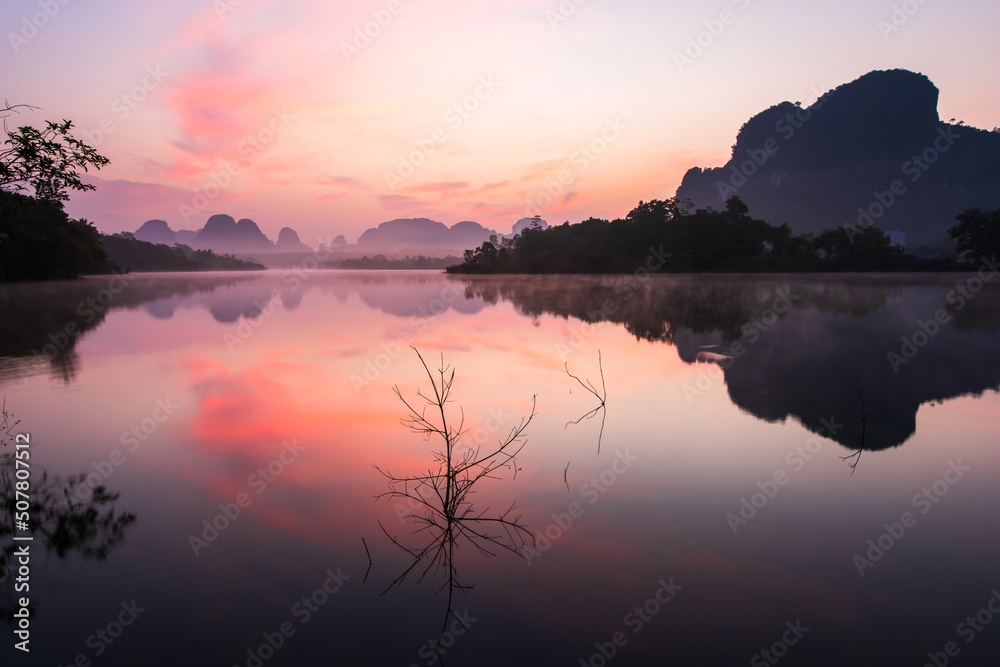 In the landscape of the tropical lake during sunrise.