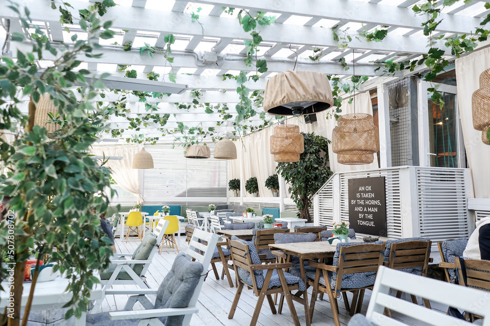 Summer terrace in a cafe, white wooden furniture.