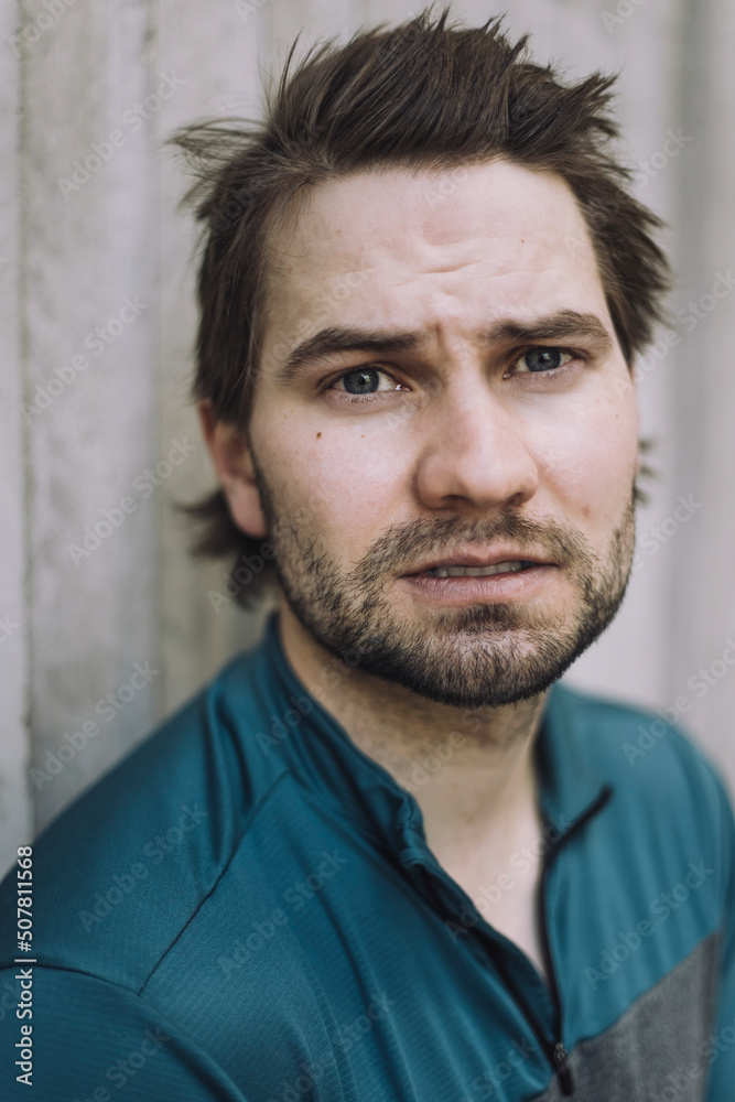 Portrait of young man standing against wall Portrait of young man standing against wall