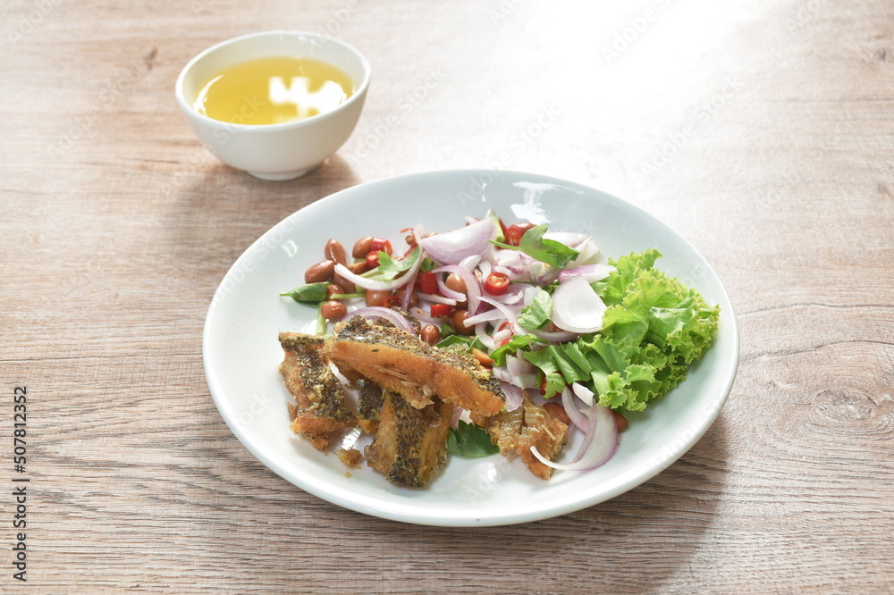 deep fried slice snake skin gourami spicy and sour Thai salad on dish deep fried slice snake skin gourami spicy and sour Thai salad on dish