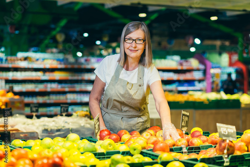 Canvastavla Portrait of senior woman in glasses at grocery store employee, supermarket