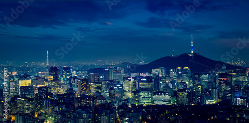 Seoul downtown cityscape illuminated with lights and Namsan Seoul Tower in the evening view from Inwang mountain. Seoul, South Korea. photo